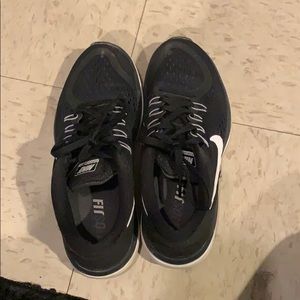 Black/white Nike running shoes.